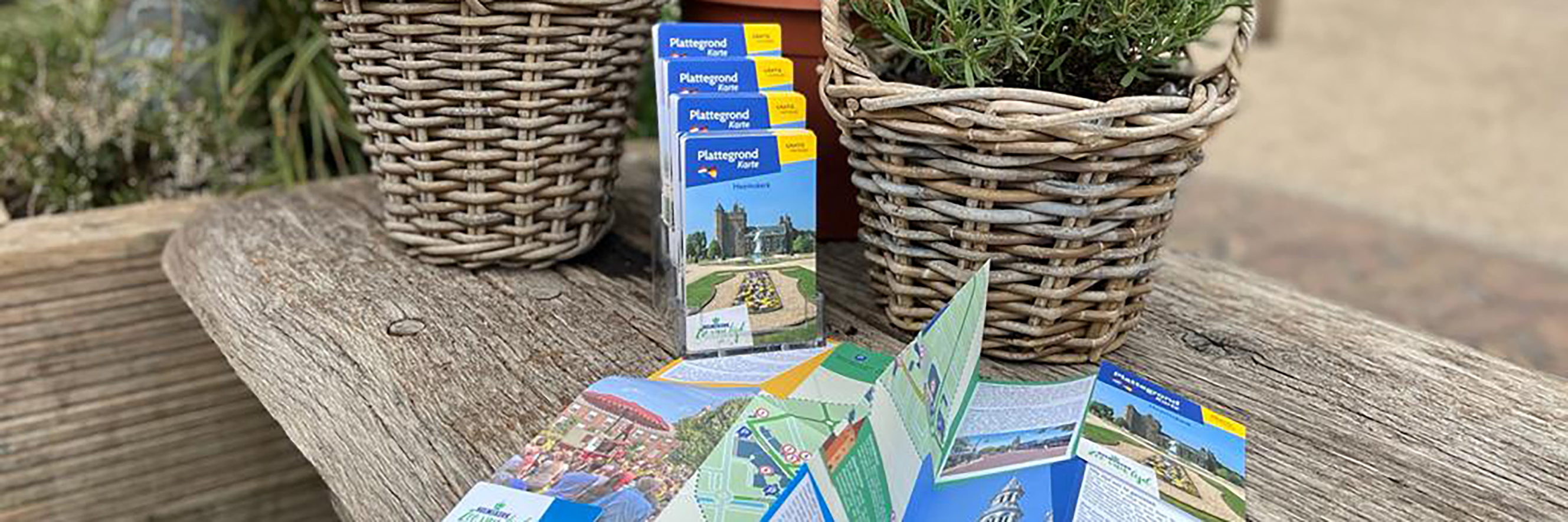 Gedrukte plattegrond van Heemskerk op een houten tafel met twee rieten manden.